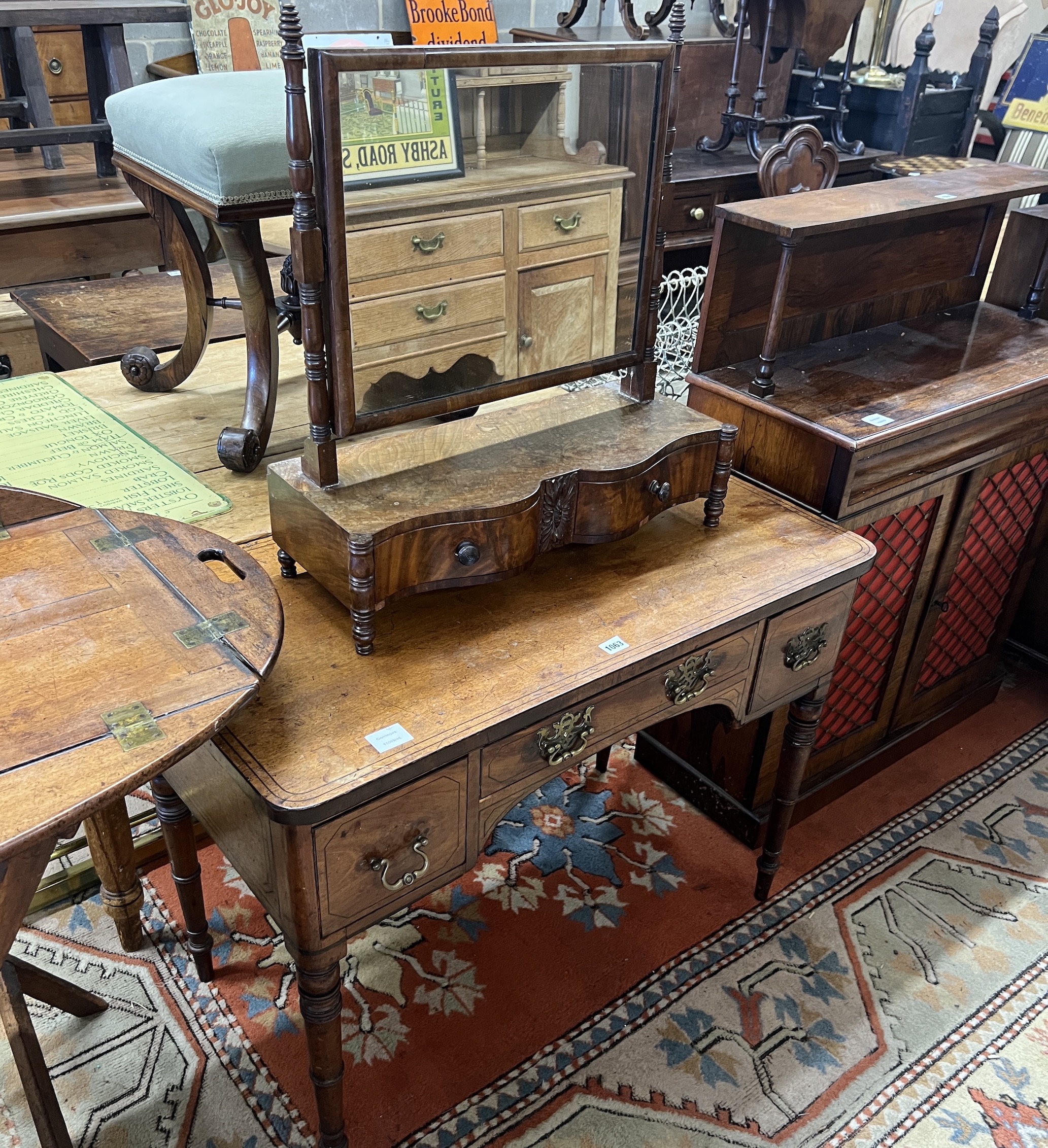 A Regency mahogany kneehole dressing table, width 94cm, depth 50cm, height 72cm together with an early Victorian mahogany serpentine front toilet mirror
